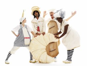 Four performers in costume gather around a huge croissant. Photo from Baking Time, credit Patrick Baldwin