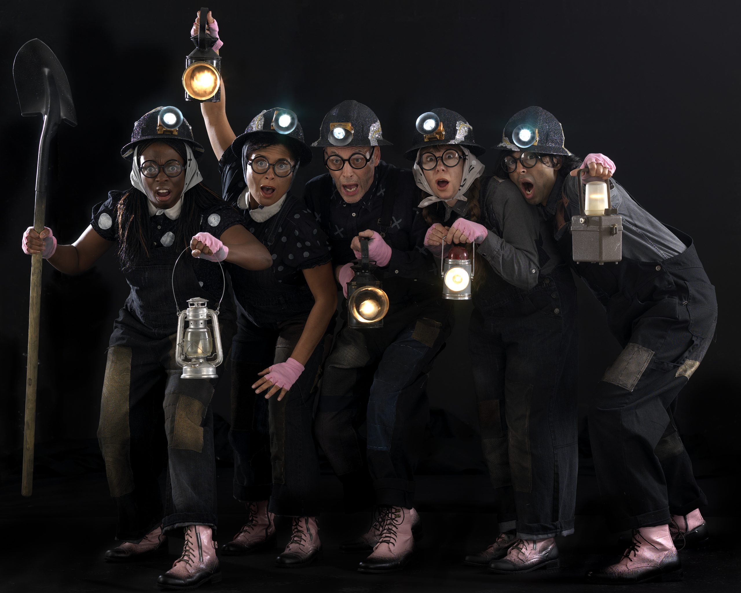 Five characters, all wearing dark costumes, holding lanterns and wearing headtorches. Photo from Mole in the Hole.