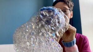 Franki blows bubbles in Trans colours.