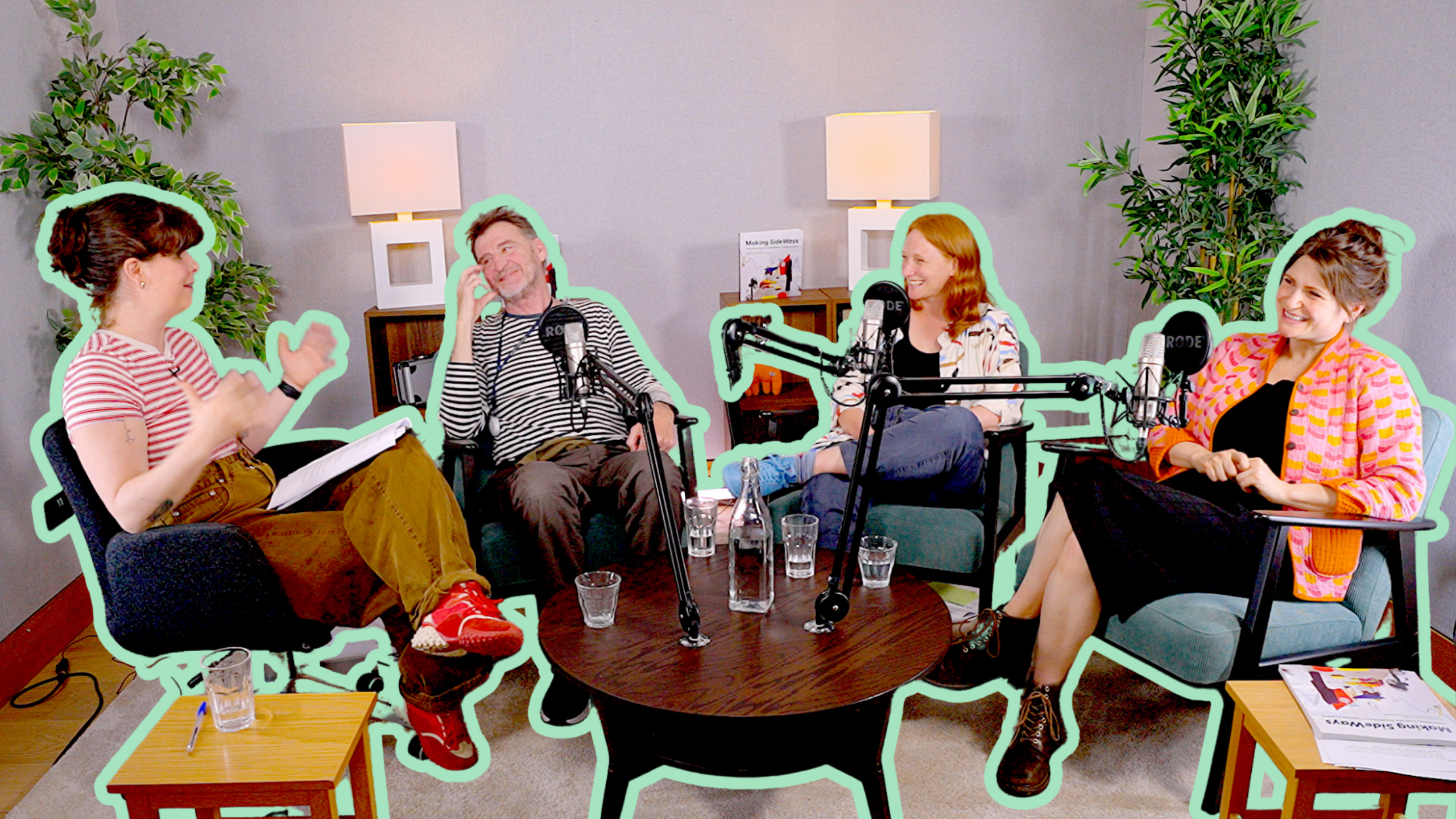 Host Flo mid-conversation with Aaron, Elspeth and Ellie. They are in a recording studio with podcast mics in front of them